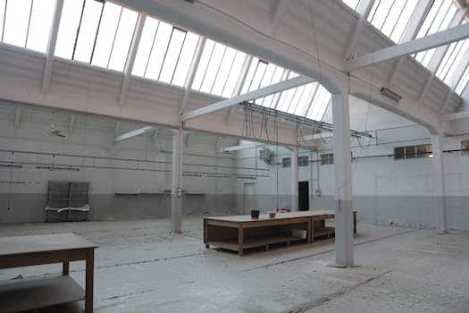 Bright premise for storage with concrete floor and metal beams inside modern industrial building