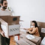 Couple Packing Things In Boxes