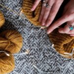 Photo Of Person Holding Brown Yarn Roll