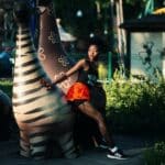 Photo of Woman Beside Zebra Statue