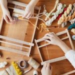 Top View Photo of Two Person's Hands Weaving