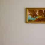 A Single Gold Framed Painting On The Wall