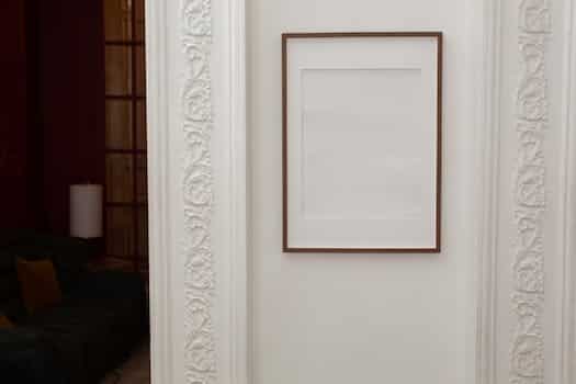 Empty white frame hanging on wall with patterns