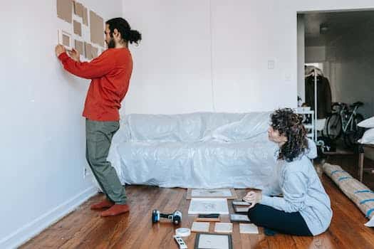 Man Putting A Frame On The Wall