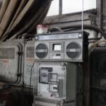 Old fashioned cassette player placed in shabby garage near old industrial equipment