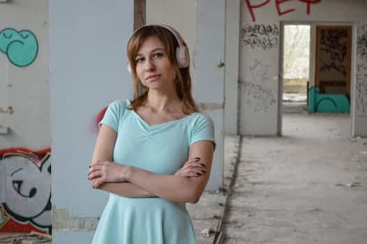 Serene woman listening to song in headset in old building