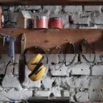 Various instruments hanging on wooden board in garage