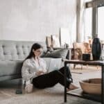 Woman Sitting On The Floor While Using Her Laptop