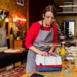 Woman Using a Stained Glass Grinder in her Workshop