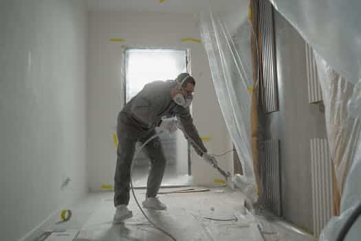 Man in Black Jacket and Black Pants Wearing White Helmet