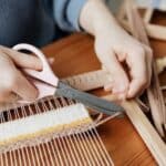 Person Cutting a Yarn