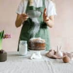 Anonymous female serving cake with icing sugar