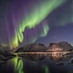 Mountain Beside Body of Water With Aurora Borealis