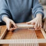 Person Weaving Using Hand Loom