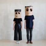 Two Persons Wearing a Diy Cardboard Box Mask