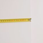 Measuring tape on empty white background