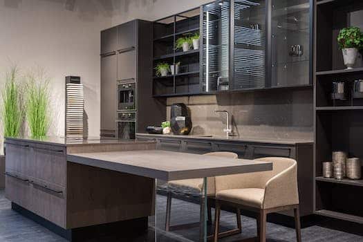 Modern trendy kitchen interior with dark cabinets and counter in spacious contemporary flat