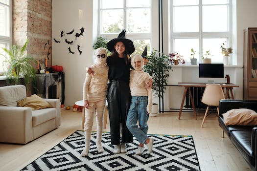 A Family Wearing Halloween Costumes While Smiling