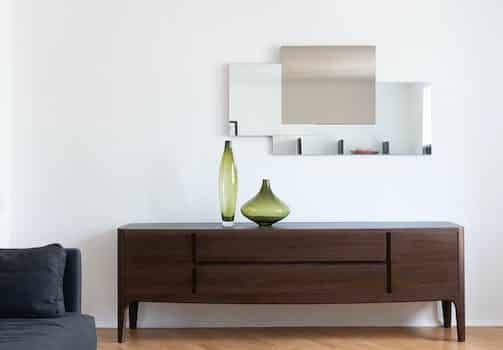 Apartment interior with cabinet with vases near mirror