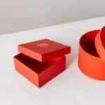 Different shapes red gift boxes on table