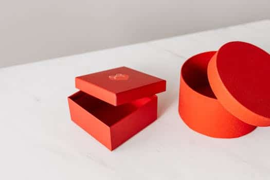 Different shapes red gift boxes on table