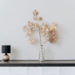 Flower Vase And Lamp On Black Vase on A Console Table