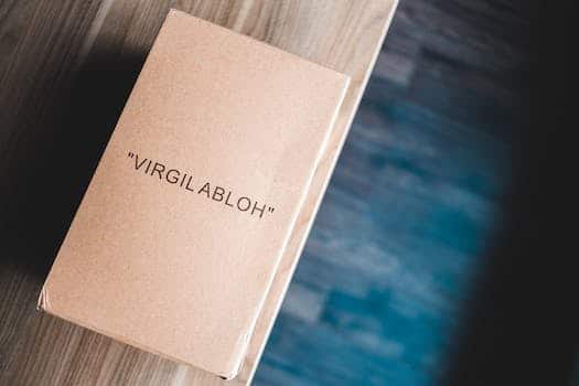 From above of cardboard box with name on front on wooden table at home