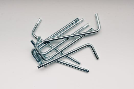 From above of different hex keys in heap on white table in workshop