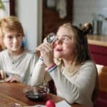 Girl Making Funny Face Using Stainless Spoon