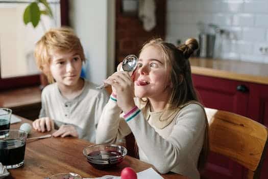 Girl Making Funny Face Using Stainless Spoon