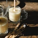 Glasses with organic candles on wooden table