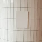 White canvas on tile wall in room