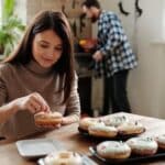 Woman Decorating Halloween Donuts