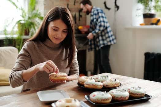 Woman Decorating Halloween Donuts