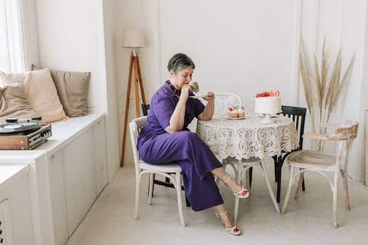 Woman in Purple Jumpsuit Holding Cup