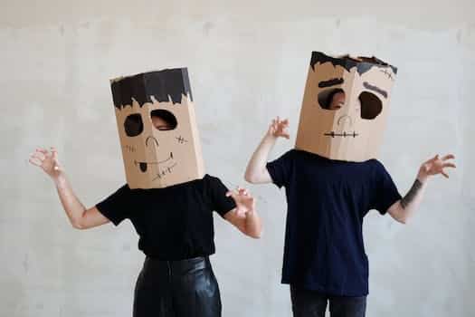 Two Persons Wearing a Diy Cardboard Box Mask